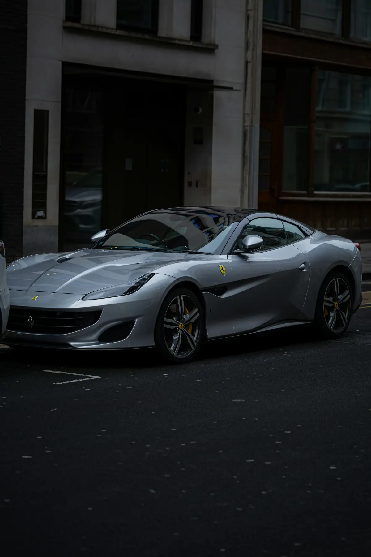 A silver sports car parked on the side of the road